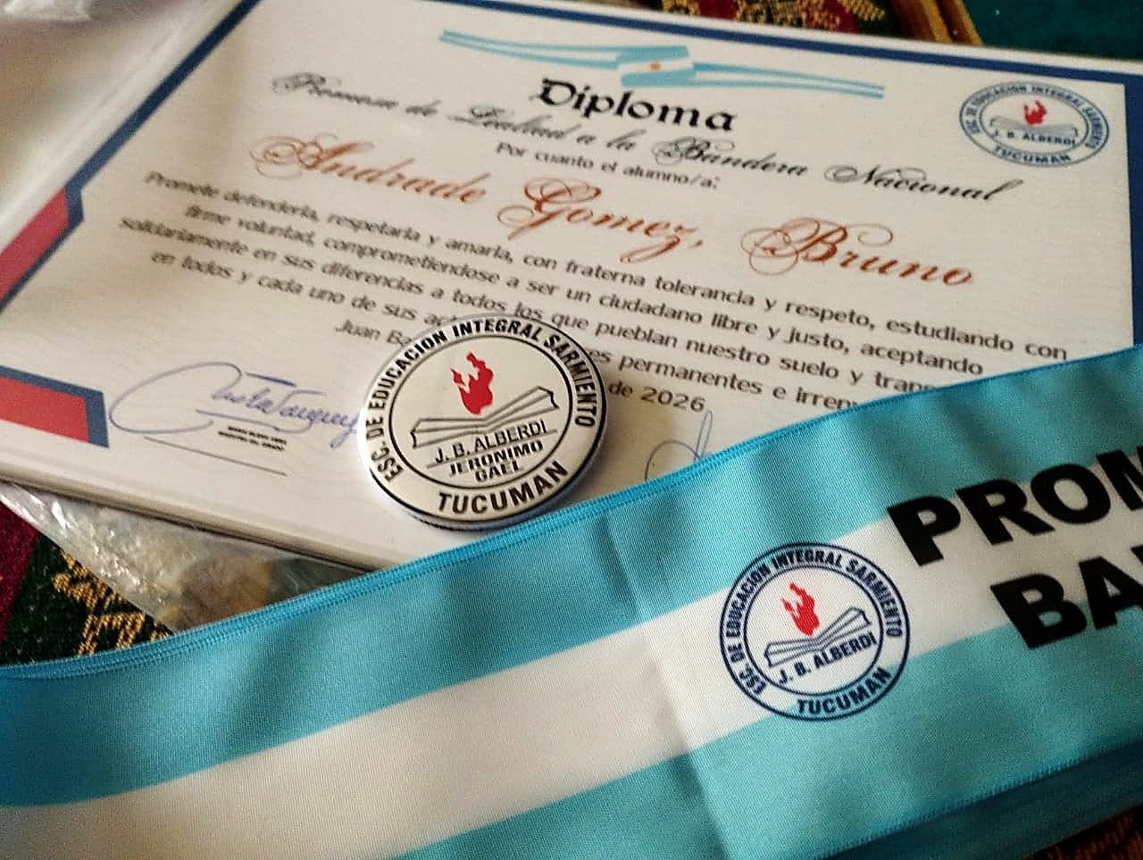 Prendedor personalizado junto a otras piezas de un acto escolar